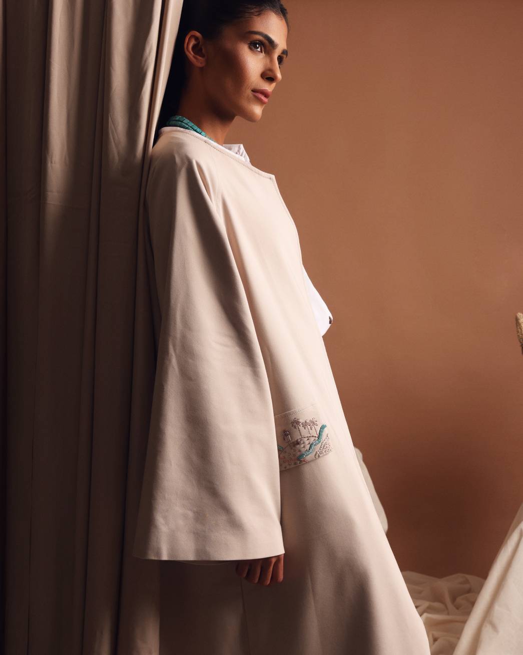 Under the palm trench coat